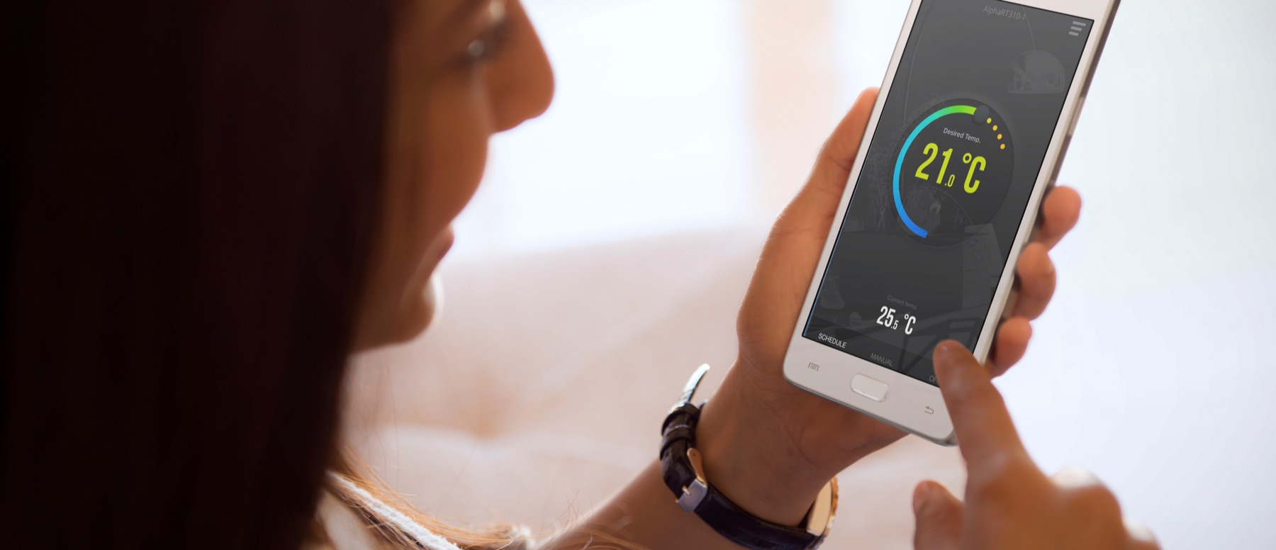 Customer controlling her heating from the Alpha Connect app